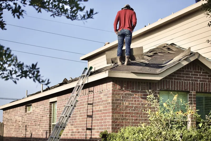 Professional roofer working on a residential roof in Multnomah Village